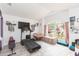 Comfortable living room with plenty of natural light, a large window and a treadmill for exercise at 34447 Blue Ash Ct, Wesley Chapel, FL 33545