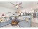 Cozy living room featuring a large sectional sofa and views into the kitchen at 34447 Blue Ash Ct, Wesley Chapel, FL 33545