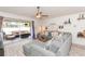 Bright living room with a sliding glass door leading to the screened patio at 34447 Blue Ash Ct, Wesley Chapel, FL 33545