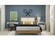 Modern bedroom with tennis rackets, stylish desk, and neutral color scheme at 3465 Lapis Lake Dr, Zephyrhills, FL 33541