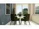 A dining nook with olive green seating, a round table, and neutral accents at 3465 Lapis Lake Dr, Zephyrhills, FL 33541