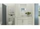 A stylish bathroom with a neutral color scheme, featuring a modern vanity, toilet, and decorative artwork at 3481 Lapis Lake Dr, Zephyrhills, FL 33541