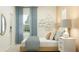 An inviting bedroom with a comfortable bed, stylish decor, window views, and honey-comb wall art at 3481 Lapis Lake Dr, Zephyrhills, FL 33541