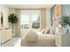 Bright main bedroom with a comfortable bed, stylish dresser, and plenty of natural light at 3481 Lapis Lake Dr, Zephyrhills, FL 33541