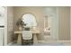 Chic office space with a modern desk, round mirror, and view into a serene bedroom at 3481 Lapis Lake Dr, Zephyrhills, FL 33541