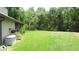 Large, well-maintained backyard with a lush green lawn and mature trees at 3914 Roswell Pl, Land O Lakes, FL 34639