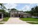Beautiful two-story home with a brick paved driveway and lush landscaping at 3914 Roswell Pl, Land O Lakes, FL 34639