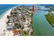 Panoramic aerial view of the coastal community featuring a scenic beach and picturesque marina at 399 2Nd St # 217, Indian Rocks Beach, FL 33785