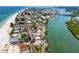 Panoramic aerial view of the coastal community featuring a scenic beach and picturesque marina at 399 2Nd St # 217, Indian Rocks Beach, FL 33785