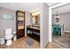 Well-lit bathroom with granite countertop, convenient shelving, and tile floors at 399 2Nd St # 217, Indian Rocks Beach, FL 33785