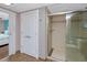 Modern bathroom with glass shower, tile flooring, and white door at 399 2Nd St # 217, Indian Rocks Beach, FL 33785