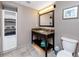 Bathroom featuring a granite-topped vanity, a mirror, and storage shelves for convenience at 399 2Nd St # 217, Indian Rocks Beach, FL 33785