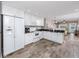 Bright kitchen features white cabinets, granite counters, and stainless appliances at 399 2Nd St # 217, Indian Rocks Beach, FL 33785