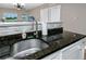 Close-up of the kitchen sink with granite countertops at 399 2Nd St # 217, Indian Rocks Beach, FL 33785