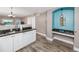 Kitchen area with white cabinets and a built-in desk with shelving at 399 2Nd St # 217, Indian Rocks Beach, FL 33785