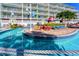 Relaxing lazy river feature at the resort, surrounded by palm trees and lounge chairs for a serene vacation experience at 399 2Nd St # 217, Indian Rocks Beach, FL 33785