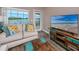 Comfortable living room with stylish furnishings, wood floors, and a view of the water at 399 2Nd St # 217, Indian Rocks Beach, FL 33785