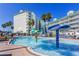 Resort pool area with fun water features and lounge chairs for a relaxing and entertaining vacation experience at 399 2Nd St # 217, Indian Rocks Beach, FL 33785