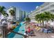 Inviting resort pool area with lazy river, lounge chairs, and palm trees, creating a relaxing tropical atmosphere at 399 2Nd St # 217, Indian Rocks Beach, FL 33785
