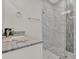 Bathroom featuring a white cabinet with granite countertop, sink, modern fixtures, and tiled walk-in shower at 4071 45Th N Ave, St Petersburg, FL 33714