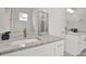 Bathroom featuring a white cabinet with granite countertop, sink, framed mirror and modern fixtures at 4071 45Th N Ave, St Petersburg, FL 33714