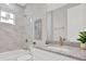 Bathroom featuring a shower over tub, white cabinet with granite countertop, sink, framed mirror and modern fixtures at 4071 45Th N Ave, St Petersburg, FL 33714