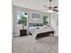 Bright bedroom featuring neutral walls, cozy carpet, ceiling fan, and large windows allowing plenty of natural light at 4071 45Th N Ave, St Petersburg, FL 33714