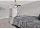Bedroom featuring neutral walls, cozy carpet, ceiling fan, and open doors allowing plenty of natural light at 4071 45Th N Ave, St Petersburg, FL 33714