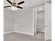 Bedroom featuring neutral walls, cozy carpet, ceiling fan, and a doorway to a closet at 4071 45Th N Ave, St Petersburg, FL 33714