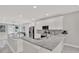 Open-concept kitchen featuring white cabinetry, granite countertops, stainless steel appliances at 4071 45Th N Ave, St Petersburg, FL 33714