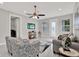 Spacious living room with a decorative ceiling fan, tiled flooring, and modern decor at 4071 45Th N Ave, St Petersburg, FL 33714