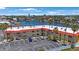 Waterfront condo building with palm trees, parking, and canal views offers relaxed coastal living at 4103 Gulf Blvd # 107, St Pete Beach, FL 33706