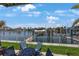 Outdoor seating area with water views and boat lift at 4103 Gulf Blvd # 107, St Pete Beach, FL 33706