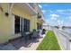 Back porch features outdoor seating with water views at 4103 Gulf Blvd # 107, St Pete Beach, FL 33706