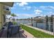 Porch overlooking waterfront features outdoor seating and boat lift at 4103 Gulf Blvd # 107, St Pete Beach, FL 33706