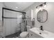 Updated bathroom features a sleek glass-enclosed shower and modern fixtures at 4103 Gulf Blvd # 107, St Pete Beach, FL 33706