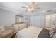 Bedroom shows ceiling fan, closet doors, dresser, and reading chair at 4103 Gulf Blvd # 107, St Pete Beach, FL 33706
