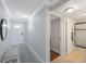 Condo entryway featuring a bench, hallway, and doorway view to bathroom at 4103 Gulf Blvd # 107, St Pete Beach, FL 33706