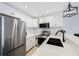 Kitchen featuring stainless steel appliances, quartz countertops, and an undermount sink at 4103 Gulf Blvd # 107, St Pete Beach, FL 33706