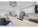 Modern condo kitchen featuring stainless steel appliances, white cabinets, and quartz countertops at 4103 Gulf Blvd # 107, St Pete Beach, FL 33706