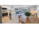 Open-concept living room features sliding glass door to balcony and updated kitchen at 4103 Gulf Blvd # 107, St Pete Beach, FL 33706