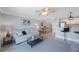 Open concept living room shows dining area and kitchen with breakfast bar at 4103 Gulf Blvd # 107, St Pete Beach, FL 33706
