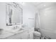 Bathroom features white cabinetry, stone counters, decorative mirror and a shower with white subway tile at 419 S Shore Crest Dr, Tampa, FL 33609