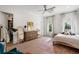 Bedroom with hardwood floors features a ceiling fan, dresser, and an adjacent walk-in closet at 419 S Shore Crest Dr, Tampa, FL 33609