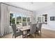 Bright dining room featuring hardwood floors, modern lighting fixture and a large window at 419 S Shore Crest Dr, Tampa, FL 33609