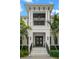 Elegant home entrance featuring marble steps, black railings, and a covered balcony with a stylish light fixture at 419 S Shore Crest Dr, Tampa, FL 33609