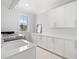 Bright laundry room features white cabinetry, modern appliances, and a sink at 419 S Shore Crest Dr, Tampa, FL 33609