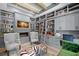 Sophisticated library with custom built-in bookshelves, a cozy fireplace, and comfortable seating at 419 S Shore Crest Dr, Tampa, FL 33609