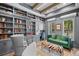 Cozy library with custom built-in bookshelves, rolling ladder, comfortable seating, and natural light at 419 S Shore Crest Dr, Tampa, FL 33609