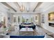 Bright living room boasts a fireplace, beamed ceiling, and French doors overlooking the backyard at 419 S Shore Crest Dr, Tampa, FL 33609